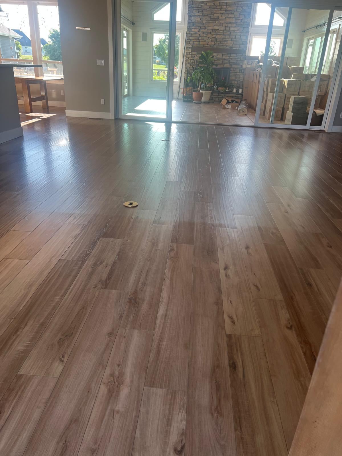 Open living area with clean wood-look floors ready for move-in