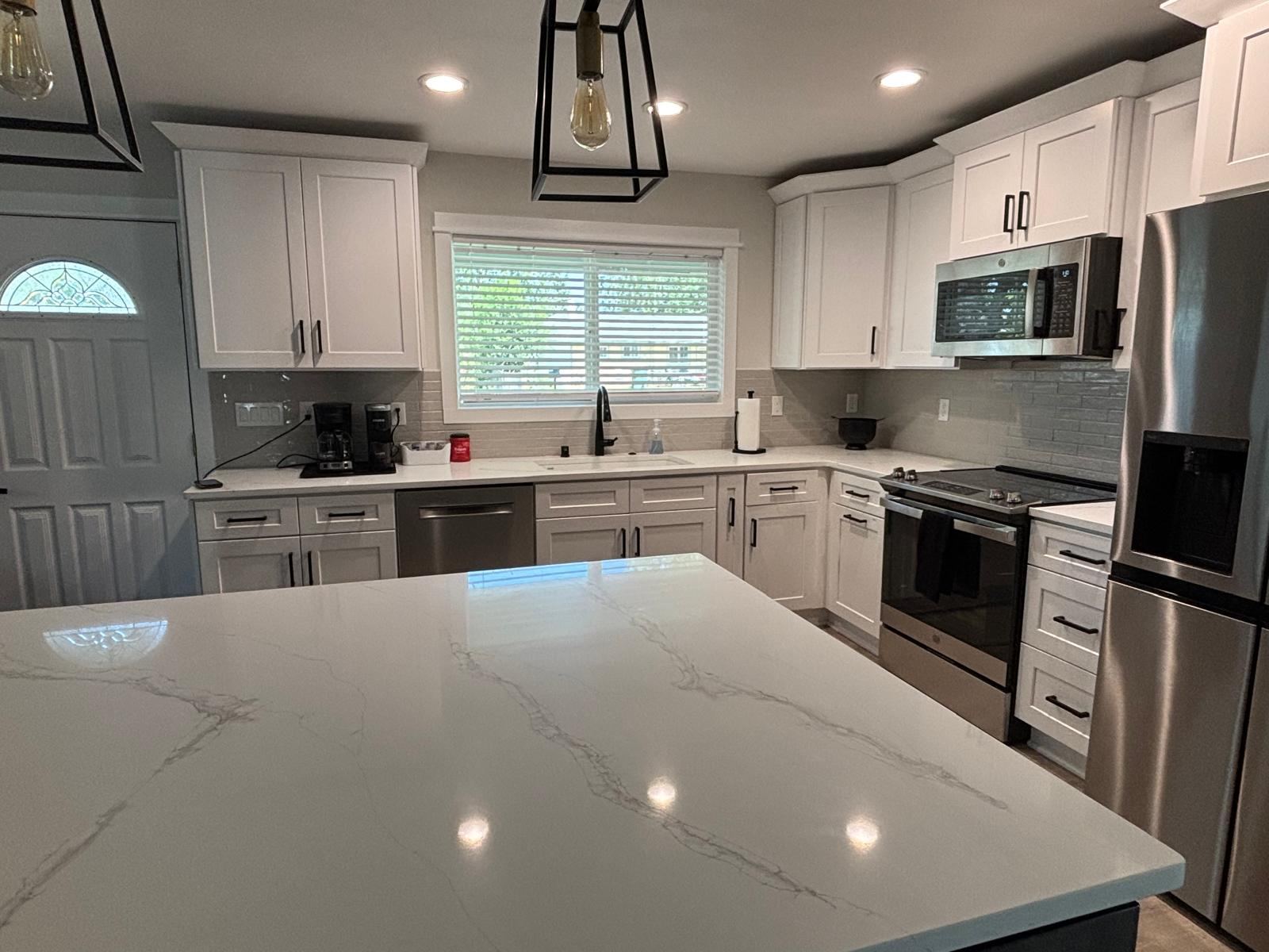 Deep cleaned kitchen with a polished quartz island