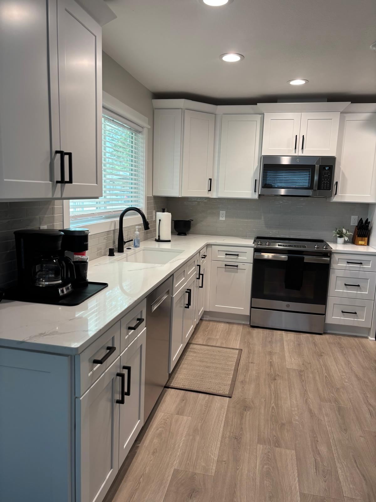 Clean white kitchen with quartz counters after a residential cleaning