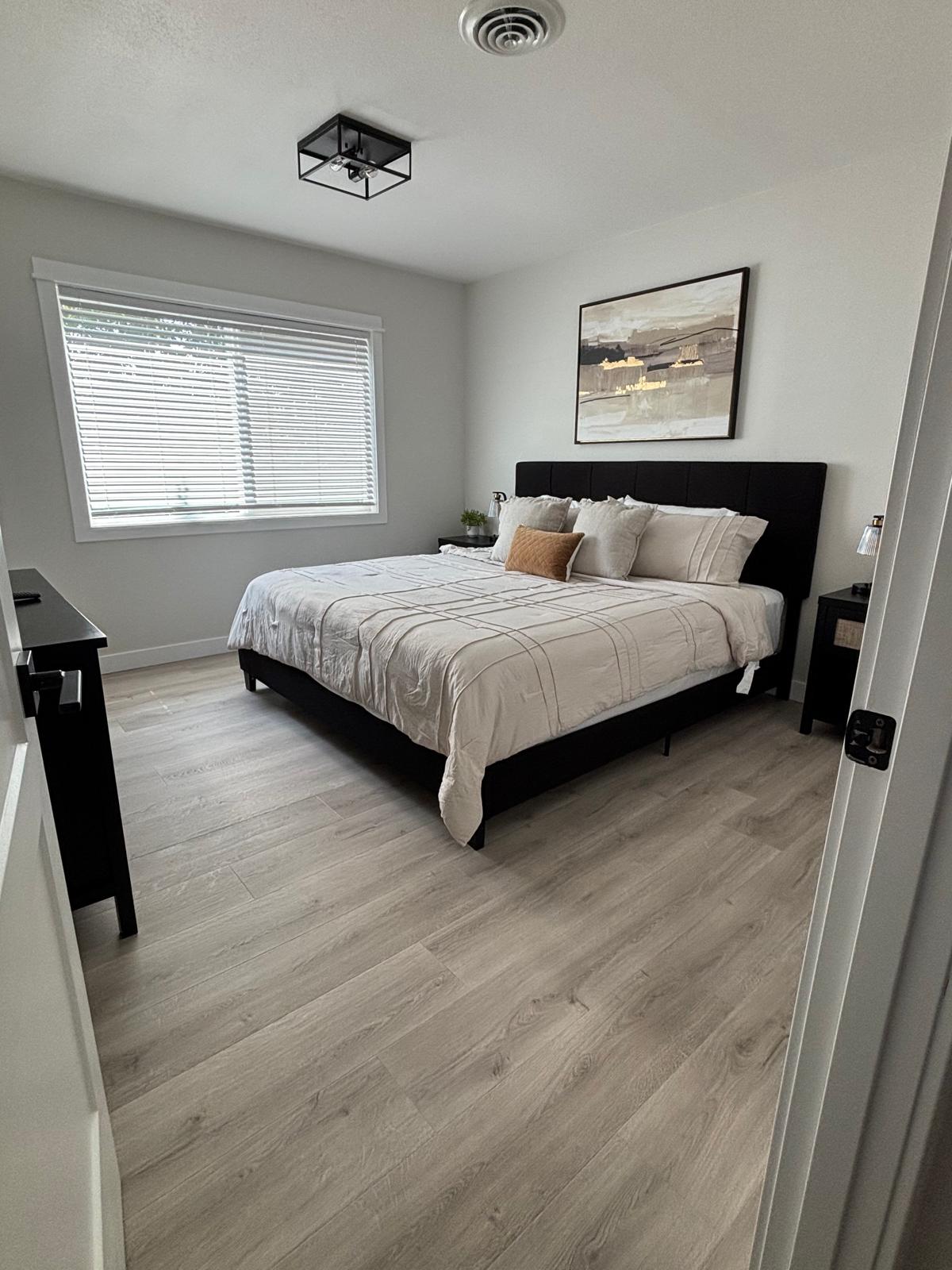 Made king bed with decorative pillows in a bright bedroom