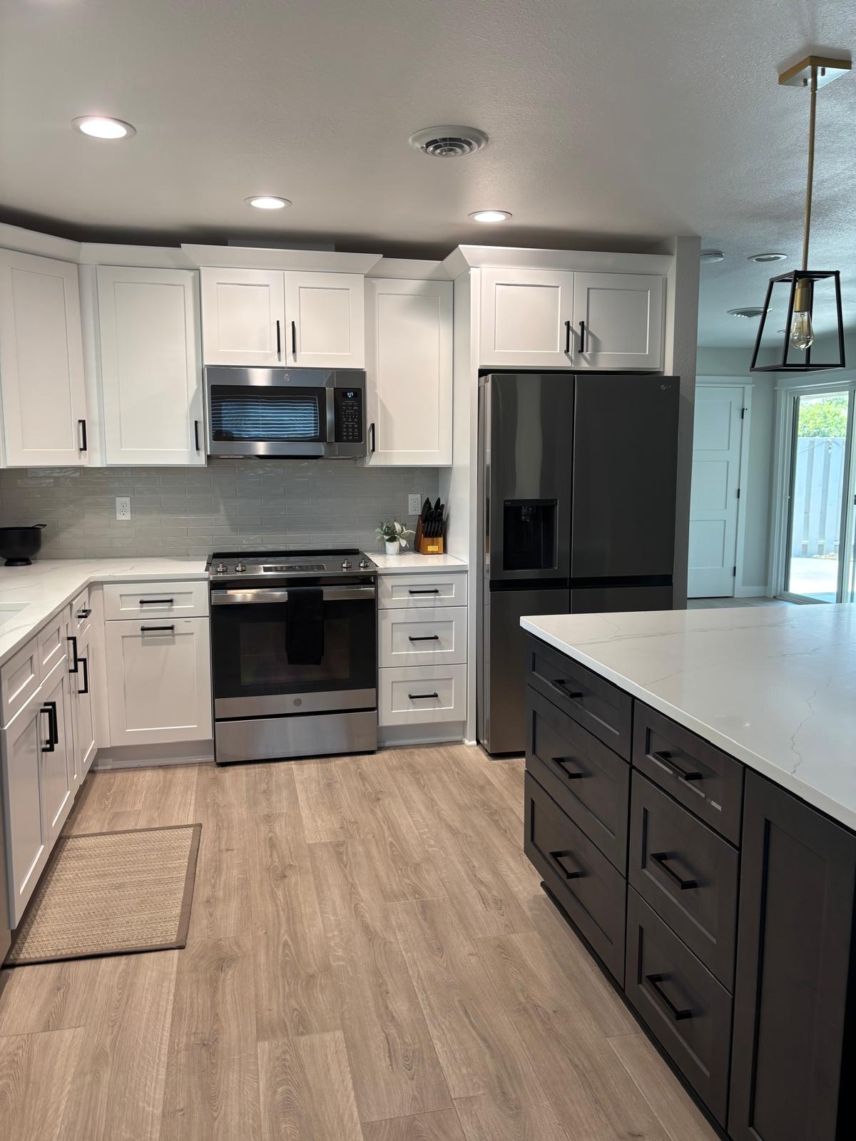 Kitchen with stainless appliances and clean white cabinets