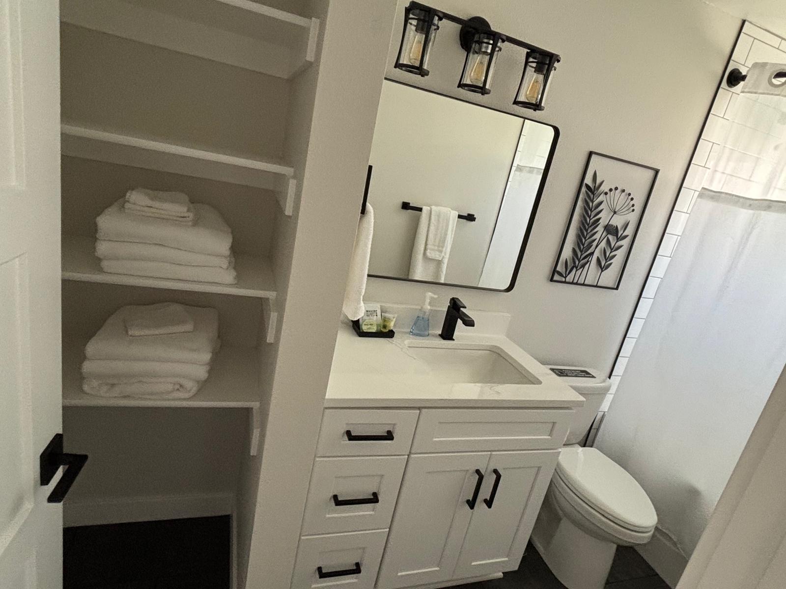 Bathroom vanity with mirror, black hardware and tidy counter