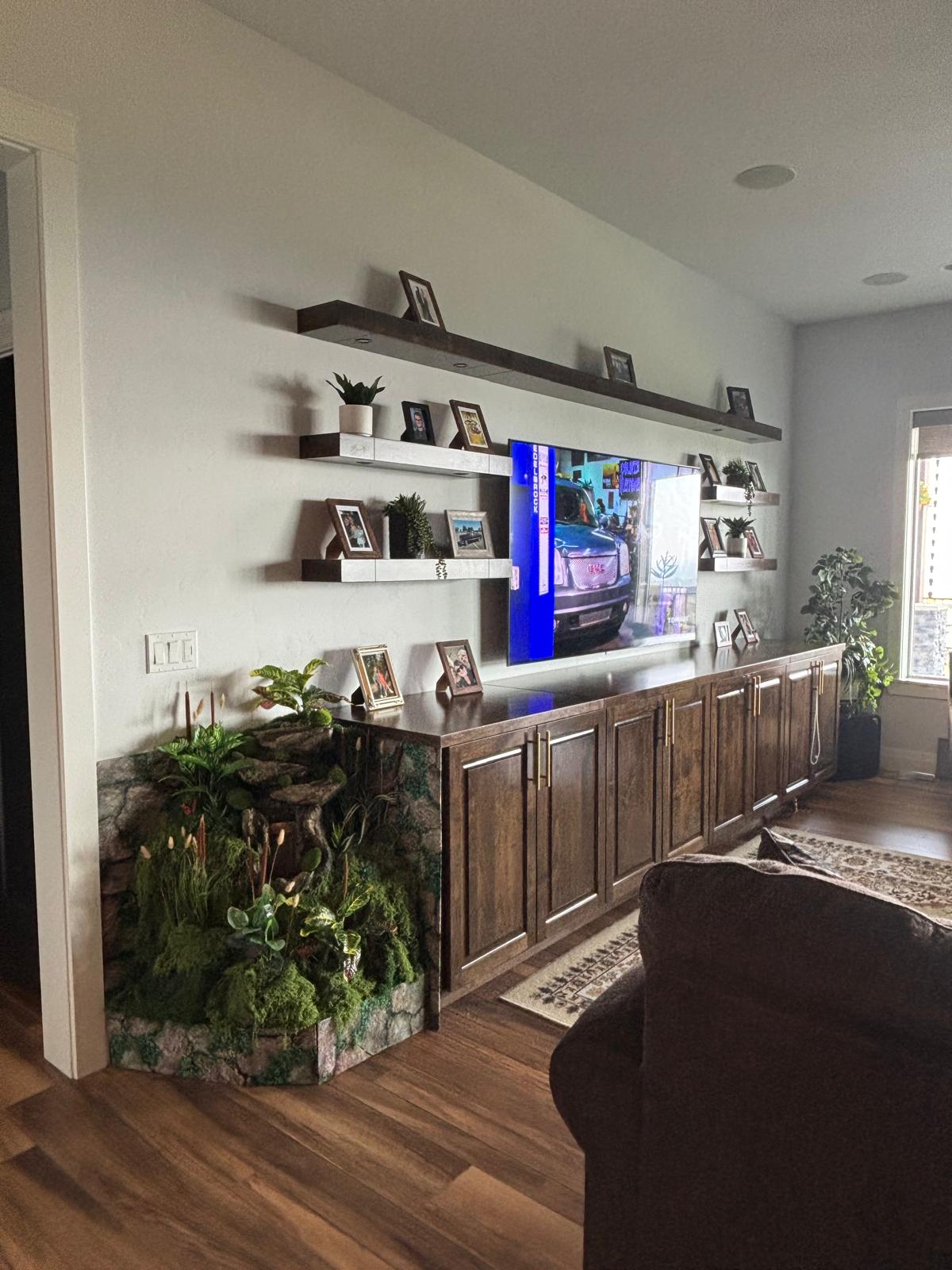 Built-in entertainment wall with tidy shelves and clean wood floors