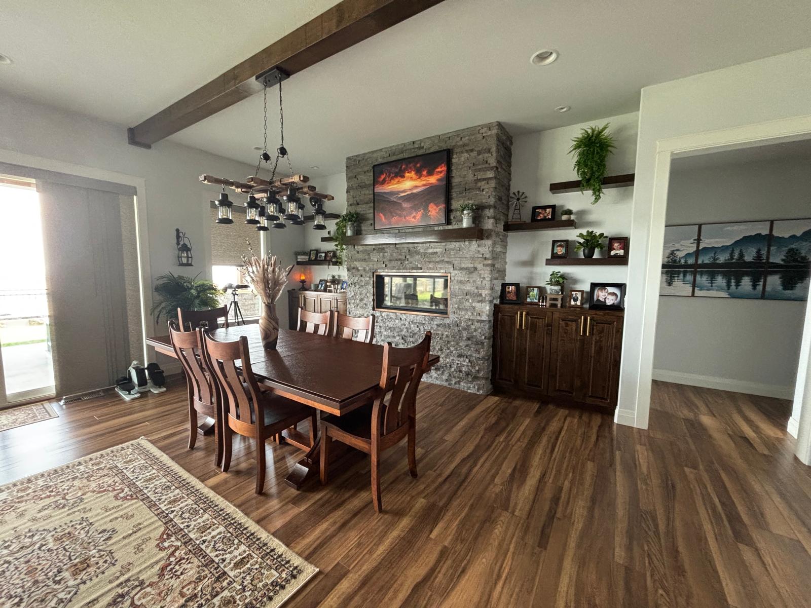 Living and dining area with stone fireplace, cleaned and staged
